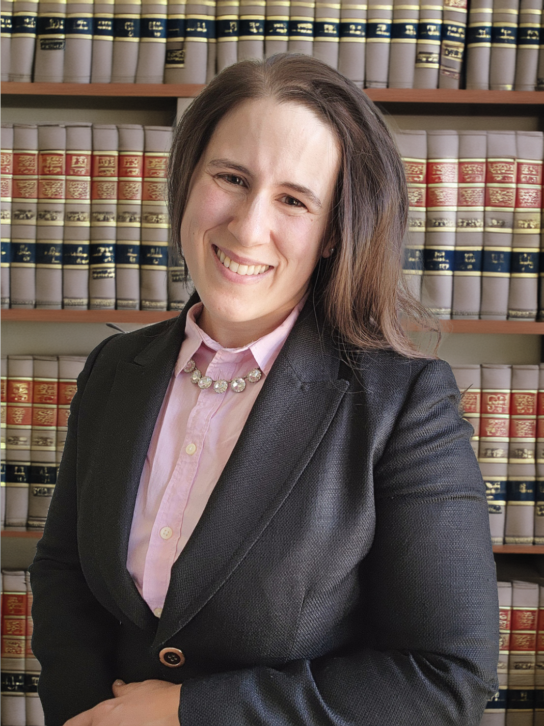 photo of a professional woman with law books behind her