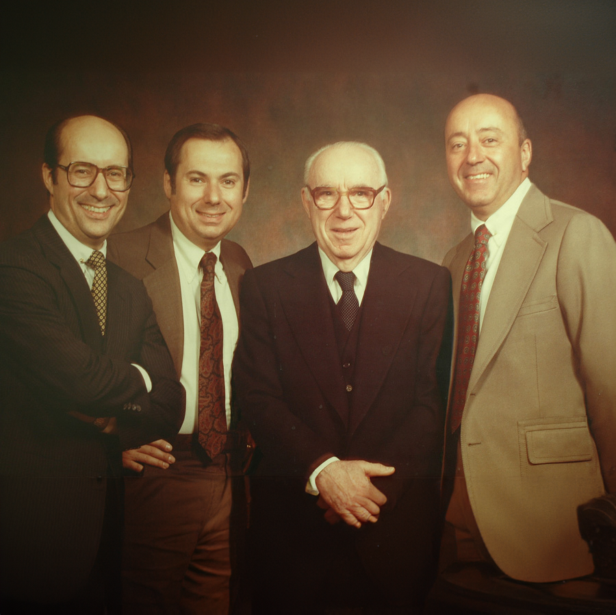 old photo of four men in suits